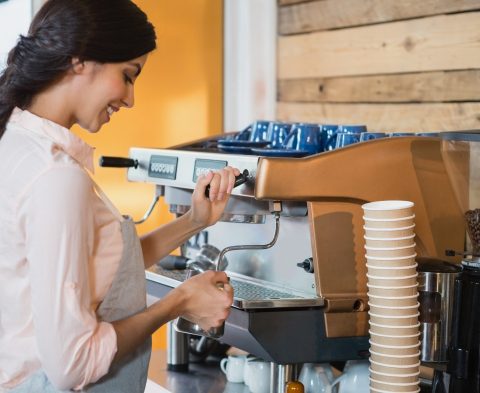 Waitress using coffeemaker